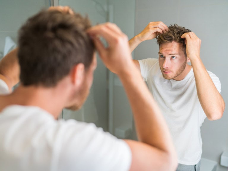 Man applying hair cream