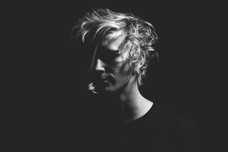 man with black t-shirt and blonde hair