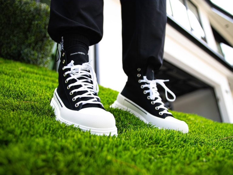 man wearing black and white shoes