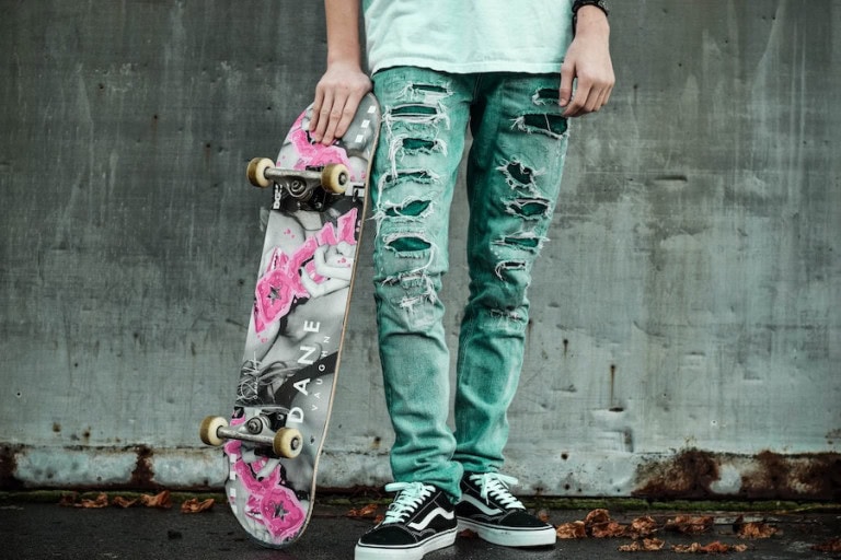 man wearing green patched jeans