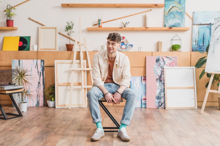 artist wearing light wash denim jeans