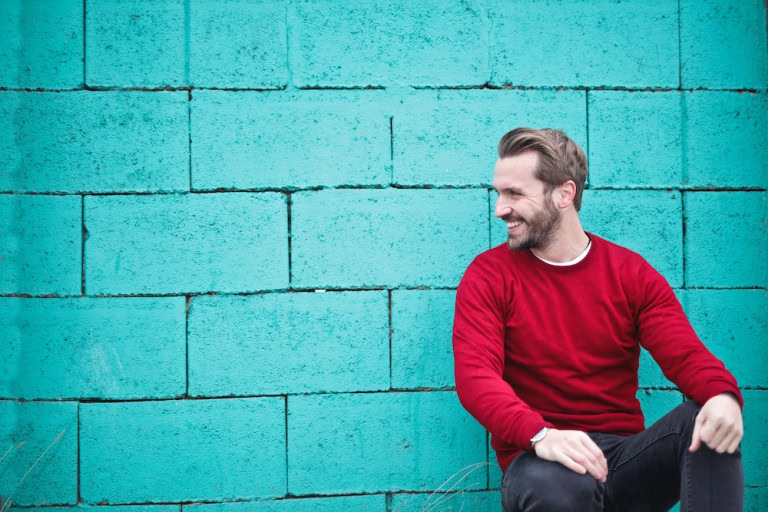 man flaunting red crew neck sweater