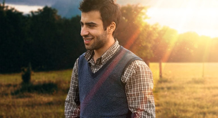 man wearing blue sweater vest