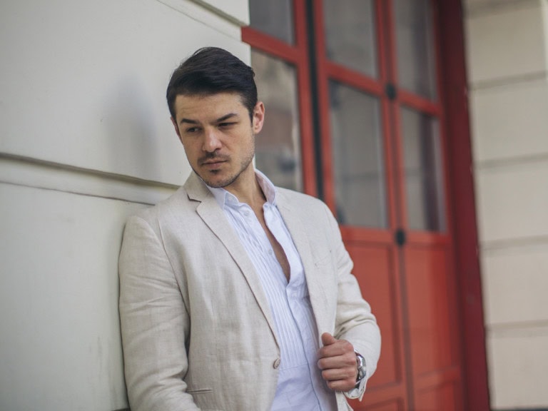 man wearing beige linen suit