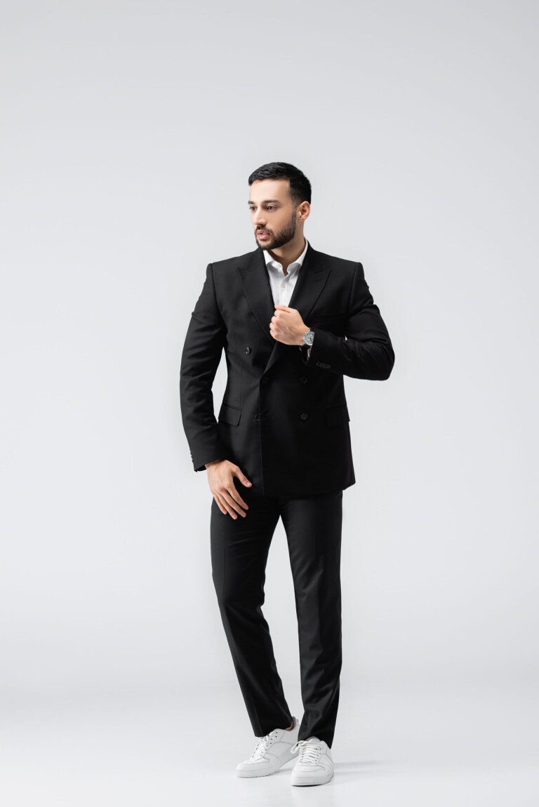 man wearing suit with white sneakers