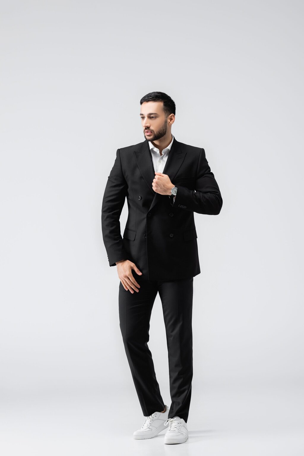 man wearing suit with white sneakers