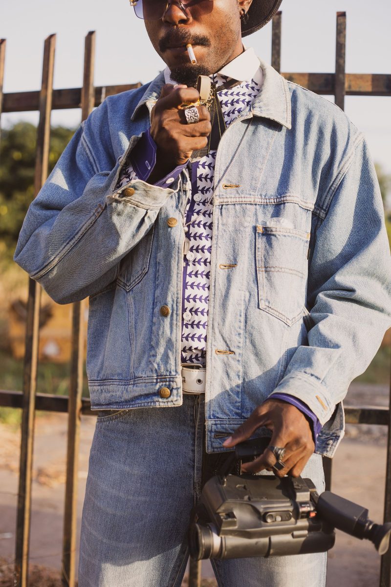Man in double denim holding a camcorder, 90s style