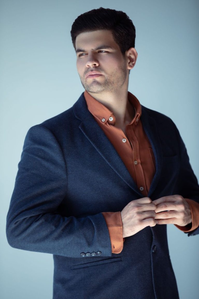 Man in a blue blazer and brown shirt, classic Sunday style