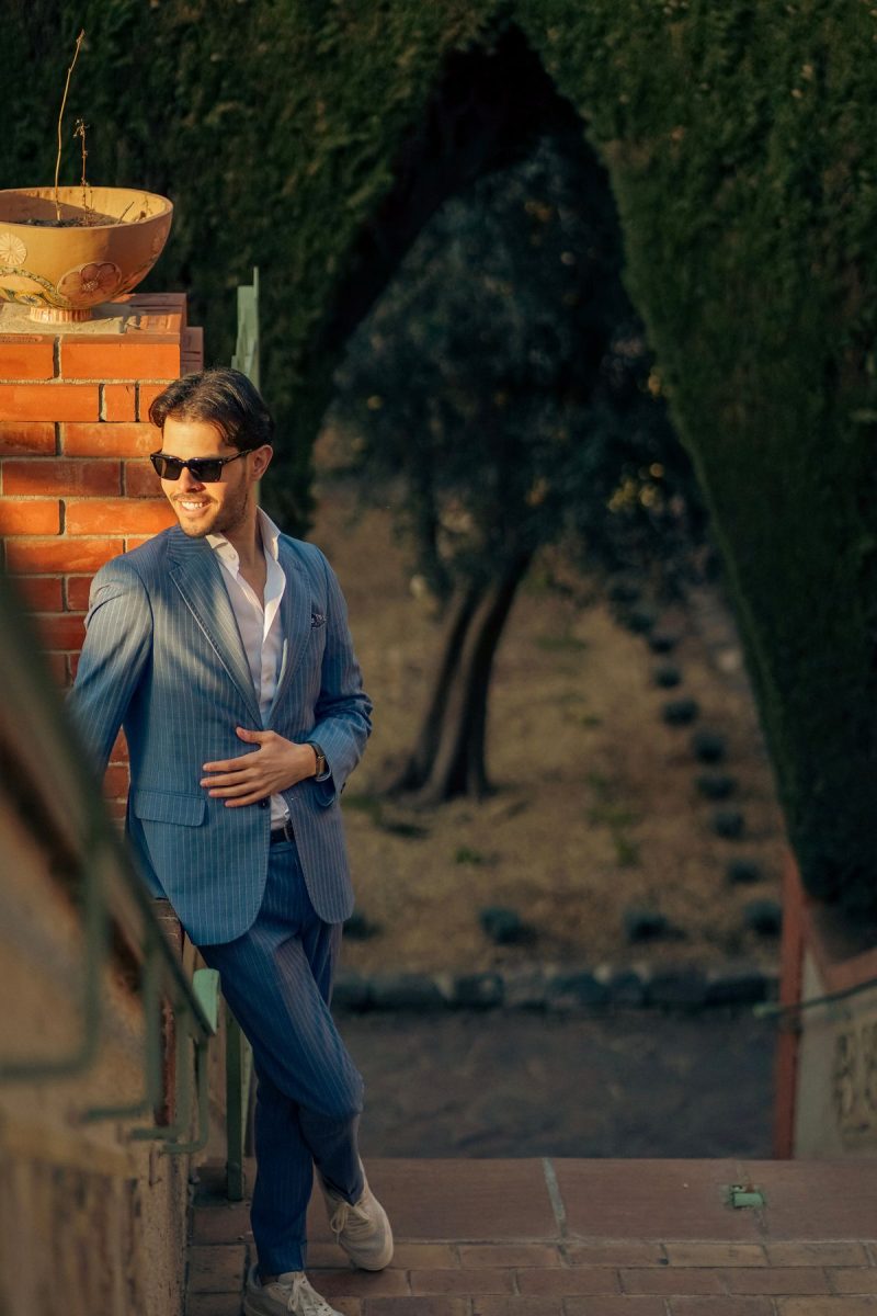 Man in a blue suit outdoors in golden summer light