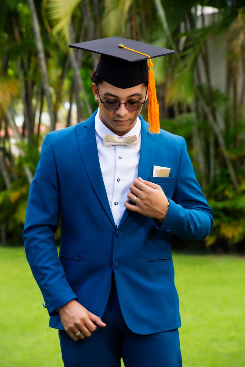 Man in a royal blue tuxedo, full length, against a clean background